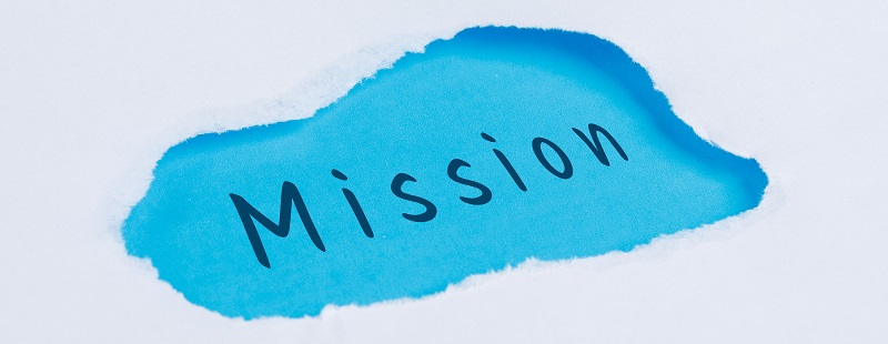 Marketing concept with mission word on blue and white background flat lay.